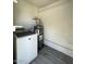 This utility room features white brick walls, a water heater and a washing machine at 5420 W Lynwood St, Phoenix, AZ 85043