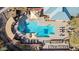 Aerial view of community pool and spa, surrounded by seating and lush landscaping at 583 W Bismark St, San Tan Valley, AZ 85143