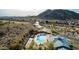 Panoramic aerial view of the community featuring a pool, spa, and nearby mountains at 583 W Bismark St, San Tan Valley, AZ 85143