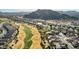 Panoramic aerial view of the golf course and community, set against the backdrop of mountains at 583 W Bismark St, San Tan Valley, AZ 85143
