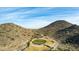Aerial view of a desert golf course nestled between hills, showcasing the natural landscape at 583 W Bismark St, San Tan Valley, AZ 85143
