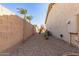 Pebbled backyard with a tan wall and native plants at 583 W Bismark St, San Tan Valley, AZ 85143