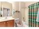 Bathroom featuring a vanity with modern fixtures, commode and a bathtub with shower at 583 W Bismark St, San Tan Valley, AZ 85143