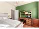 Comfortable bedroom featuring a bed, desk with shelving, and modern decor at 583 W Bismark St, San Tan Valley, AZ 85143