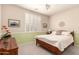Comfortable bedroom featuring a window with shutters, classic wood frame bed, and ample natural light at 583 W Bismark St, San Tan Valley, AZ 85143