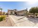 Spacious single-story home featuring desert landscaping, large driveway, and a two-car garage at 583 W Bismark St, San Tan Valley, AZ 85143