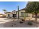 Landscaped single-story home with desert plants and mature tree at 583 W Bismark St, San Tan Valley, AZ 85143