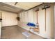 Clean garage with epoxy floors, ample storage, and shuttered windows, offering a functional space at 583 W Bismark St, San Tan Valley, AZ 85143