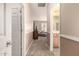 Hallway leading to a comfortably furnished living room and a bright bathroom at 583 W Bismark St, San Tan Valley, AZ 85143