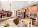 Open kitchen with breakfast bar and stainless steel appliances, offering a view into the living area at 583 W Bismark St, San Tan Valley, AZ 85143