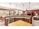 Open kitchen with breakfast bar and stainless steel appliances, offering a view into the dining and living areas at 583 W Bismark St, San Tan Valley, AZ 85143