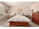 Cozy main bedroom with a classic wood bed frame, soft neutral tones, and comfortable furnishings at 583 W Bismark St, San Tan Valley, AZ 85143