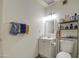 Compact bathroom featuring a white vanity, essential toiletries, and neutral wall and floor tiles at 5962 W Townley Ave, Glendale, AZ 85302