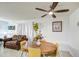 Cozy dining area featuring a round wooden table, seating for four, and a decorative ceiling fan at 5962 W Townley Ave, Glendale, AZ 85302