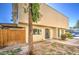 Townhouse exterior surrounded by mature trees, well-kept bushes, and a wooden fence at 5962 W Townley Ave, Glendale, AZ 85302
