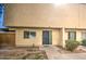Townhouse exterior with secure entry, trimmed bush, and adjacent wooden fence at 5962 W Townley Ave, Glendale, AZ 85302