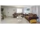 Living room showcasing stylish sofas, tile flooring, and bright natural light at 5962 W Townley Ave, Glendale, AZ 85302