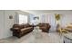 Living room featuring tile flooring, a large window, and comfortable seating at 5962 W Townley Ave, Glendale, AZ 85302