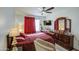 Main bedroom features a large bed, dark wood furniture, and a cozy armchair at 5962 W Townley Ave, Glendale, AZ 85302