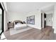Bright bedroom with modern furniture, wood floors, neutral walls, and an ensuite door at 6331 E Phoenician Blvd # 6, Scottsdale, AZ 85251