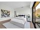 This bedroom offers a light gray rug and black-framed sliding glass door to a balcony at 6331 E Phoenician Blvd # 6, Scottsdale, AZ 85251