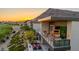 Modern home exterior featuring an open-air balcony, outdoor kitchen, and stunning mountain views at sunset at 6331 E Phoenician Blvd # 6, Scottsdale, AZ 85251