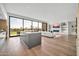 Open-concept living room with a fireplace, built-in shelves, and floor-to-ceiling windows showcasing golf course views at 6331 E Phoenician Blvd # 6, Scottsdale, AZ 85251