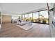 Bright open floorplan: living room with hardwood floors, modern fireplace and access to outdoor scenery at 6331 E Phoenician Blvd # 6, Scottsdale, AZ 85251