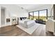 Bright main bedroom featuring golf course views, a sitting area, and access to a private balcony at 6331 E Phoenician Blvd # 6, Scottsdale, AZ 85251