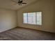 Spacious bedroom with plush carpeting, ceiling fan and large window at 7202 W Mohawk Ln, Glendale, AZ 85308