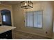 Dining area boasts an elegant chandelier, natural light, and easy access to kitchen and other living spaces at 7202 W Mohawk Ln, Glendale, AZ 85308