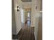 Hallway leading to a carpeted bedroom, with modern light fixtures at 7202 W Mohawk Ln, Glendale, AZ 85308