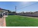 Expansive backyard showcasing a well-maintained lawn and privacy fencing at 7807 E Palm Ln, Scottsdale, AZ 85257