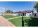 Spacious backyard features a well-manicured lawn, patio, and a fenced perimeter at 7807 E Palm Ln, Scottsdale, AZ 85257