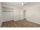 Neutral bedroom with wood-look tile, ceiling fan and closet with shelving at 7807 E Palm Ln, Scottsdale, AZ 85257