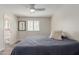 Cozy bedroom with a ceiling fan, window with shutters, and connecting bathroom at 7807 E Palm Ln, Scottsdale, AZ 85257