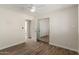 Well-lit bedroom with wood-look flooring, closet, and ensuite bathroom at 7807 E Palm Ln, Scottsdale, AZ 85257