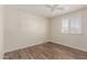 Bright bedroom with wood-look floors, white walls, and plantation shutters at 7807 E Palm Ln, Scottsdale, AZ 85257