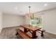 This dining area has wooden floors, a modern light fixture and access to the backyard at 7807 E Palm Ln, Scottsdale, AZ 85257