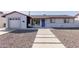 Charming home featuring decorative gravel, a concrete walkway, and a vibrant blue front door at 7807 E Palm Ln, Scottsdale, AZ 85257