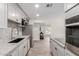 Renovated kitchen featuring stainless steel appliances, gray cabinetry, and modern fixtures at 7807 E Palm Ln, Scottsdale, AZ 85257