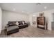 The spacious living room features wood-look tile flooring, recessed lighting and a leather couch at 7807 E Palm Ln, Scottsdale, AZ 85257