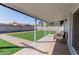 Covered patio with seating overlooks the expansive, well-maintained backyard at 7807 E Palm Ln, Scottsdale, AZ 85257