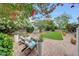Charming backyard featuring a lush lawn, brick patio, and comfortable seating for outdoor enjoyment at 9621 N 83Rd Way, Scottsdale, AZ 85258