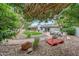 Lush backyard featuring manicured lawn, stone patio, and mature trees provides a serene outdoor retreat at 9621 N 83Rd Way, Scottsdale, AZ 85258