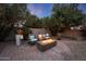 A delightful backyard featuring a cozy fire pit area surrounded by mature trees and landscape at 9621 N 83Rd Way, Scottsdale, AZ 85258