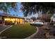 Expansive backyard featuring a lush lawn, hot tub, mature trees, and cozy outdoor seating area at 9621 N 83Rd Way, Scottsdale, AZ 85258