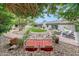 Lush backyard featuring manicured lawn, stone patio, and mature trees provides a serene outdoor retreat at 9621 N 83Rd Way, Scottsdale, AZ 85258