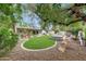 An outdoor space with manicured lawn, mature trees, and a built-in hot tub offer relaxation and beauty at 9621 N 83Rd Way, Scottsdale, AZ 85258