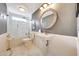Elegant bathroom with a glass-enclosed shower, pedestal sink, and stylish wall-mounted mirror at 9621 N 83Rd Way, Scottsdale, AZ 85258